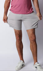 Man demonstrating the flexible stretch of chrome grey Fletch performance shorts