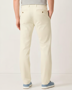 Rear view of man wearing stone Eastern stretch cotton chino pants with gray sneakers