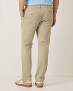 Rear view of man wearing khaki Eastern stretch cotton chino pants with beige sneakers