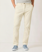 Front view of man wearing stone Eastern stretch cotton chino pants with gray sneakers